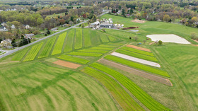 Small farm with green cover crop fields surrounding crop rows copyright Edwin Remsberg