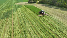 Farm equipment green chopping a cover crop field in spring