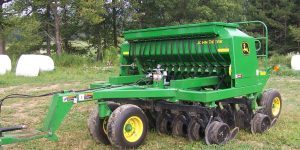 Stationery green No Till Drill in a field