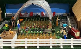 Model of a dairy farm and high tunnel with corn at State Fair 