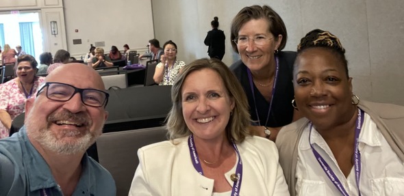 Selfie of Mark, Jenna, Izzy, & Yolanda at a conference