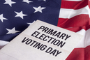 the words "Primary Election Voting Day" with the United States Flag in the background