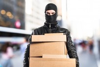 robber holding boxes