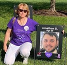 mother wearing 'I wear purple' shirt with picture of Jonathan D. at age 28