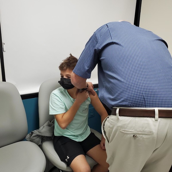 The 11-year-old son of a senior legislative aide in the Office of Councilmember Friedson receives his first dose of the COVID-19 vaccine. 
