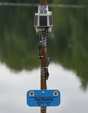 Photo of a flood sensor near a lake
