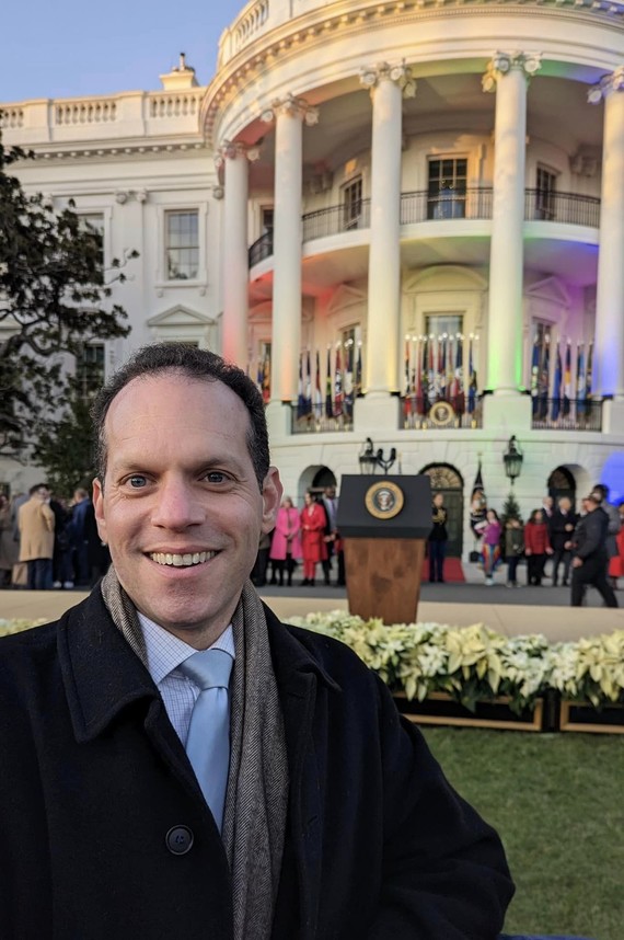 Council President Glass visits the White House. The White House is lit up with rainbow lights.