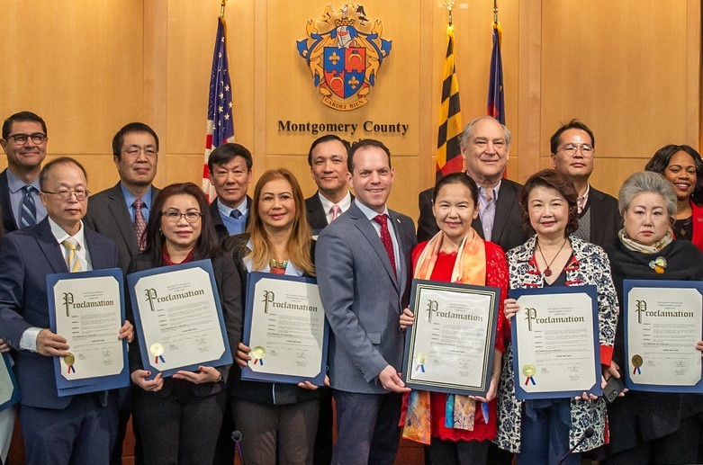 Council President Glass poses with County Executive Elrich and community members who are holding proclamations for Lunar New Year.