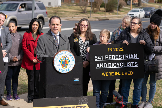 Council President Glass speaks at podium at a press conference on pedestrian safety.