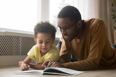 Father and preschooler reading together