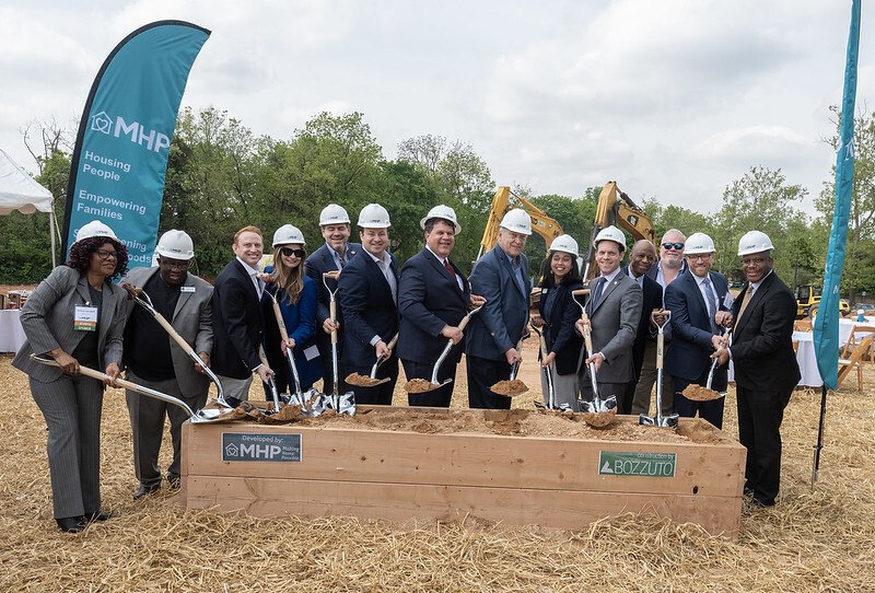 Housing leaders and elected officials pose with shovels and hard hats for groundbreaking event.