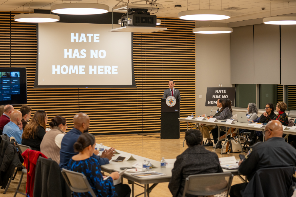 CP Glass speaks at a podium at the final Anti-Hate Task Force meeting in Wheaton.