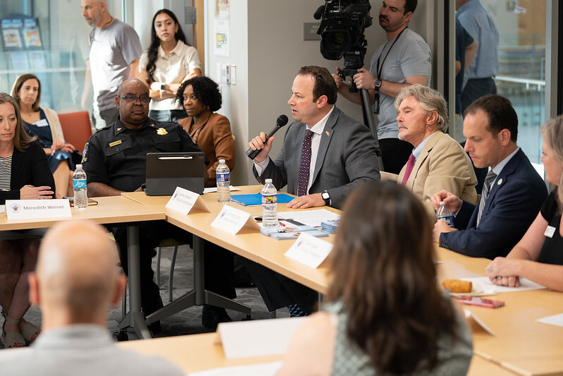 Council President Friedson speaks at an Anti-Hate Task Force meeting. He sits between Police Chief Marcus Jones and State’s Attorney John McCarthy.