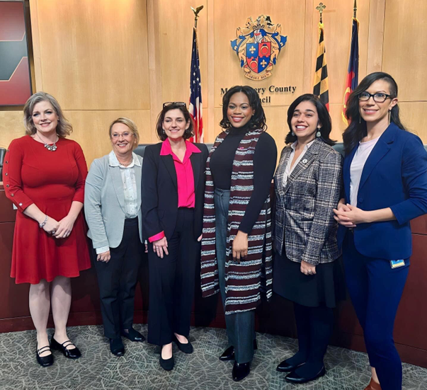 Six councilwomen on the dais