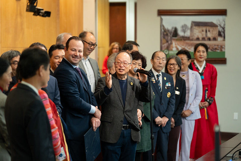Council President Friedson and Korean American community leaders speak at the Council chamber.