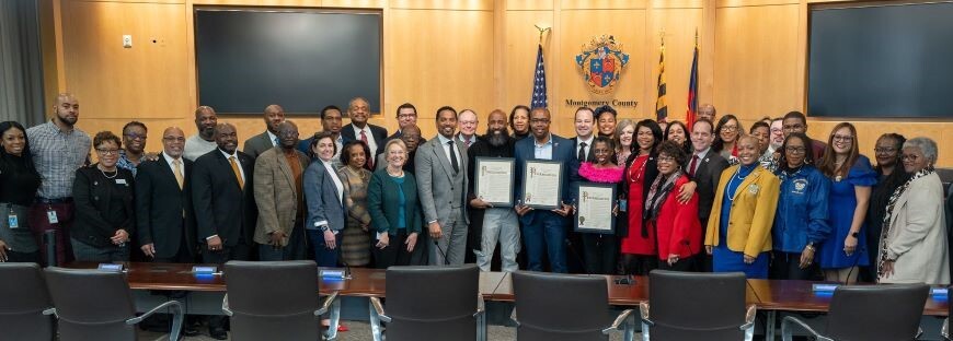 Councilmembers and community leaders pose during the Black History Month commemoration in the Council chamber.