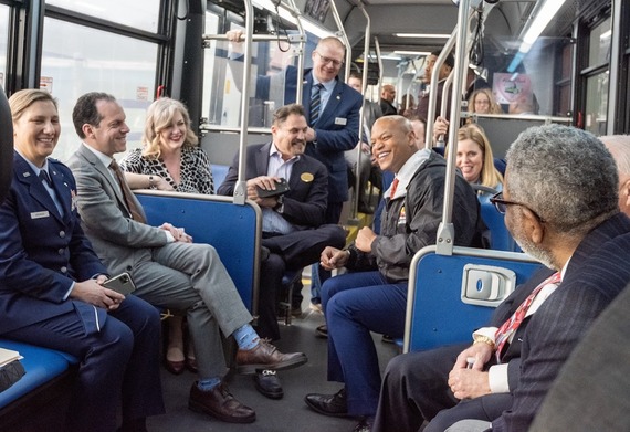 Councilmember Glass and colleagues ride a bus with Governor Wes Moore and members of his administration