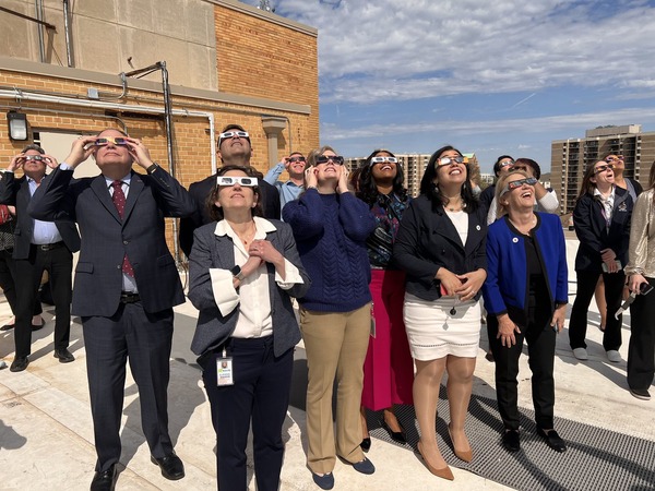 Councilmembers watch eclipse. 