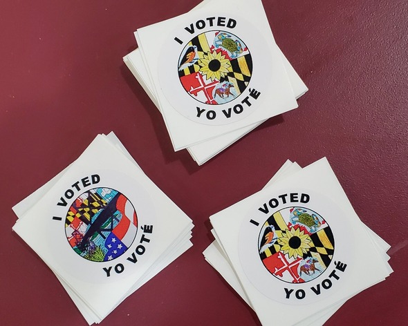 Three piles of stickers that each read "I voted" with a picture of the Maryland flag