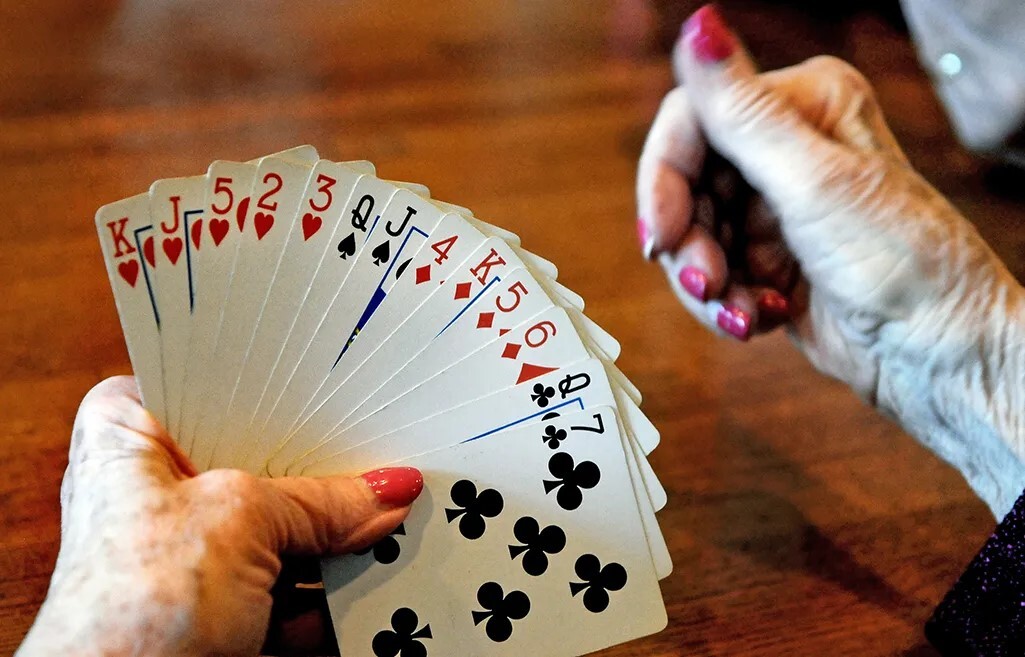 A closeup shot of someone holding a hand of playing cards