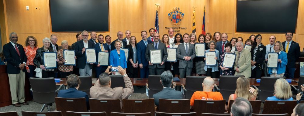 Community members and Councilmembers gather for a group photo in the Council chamber for Jewish American Heritage Month.