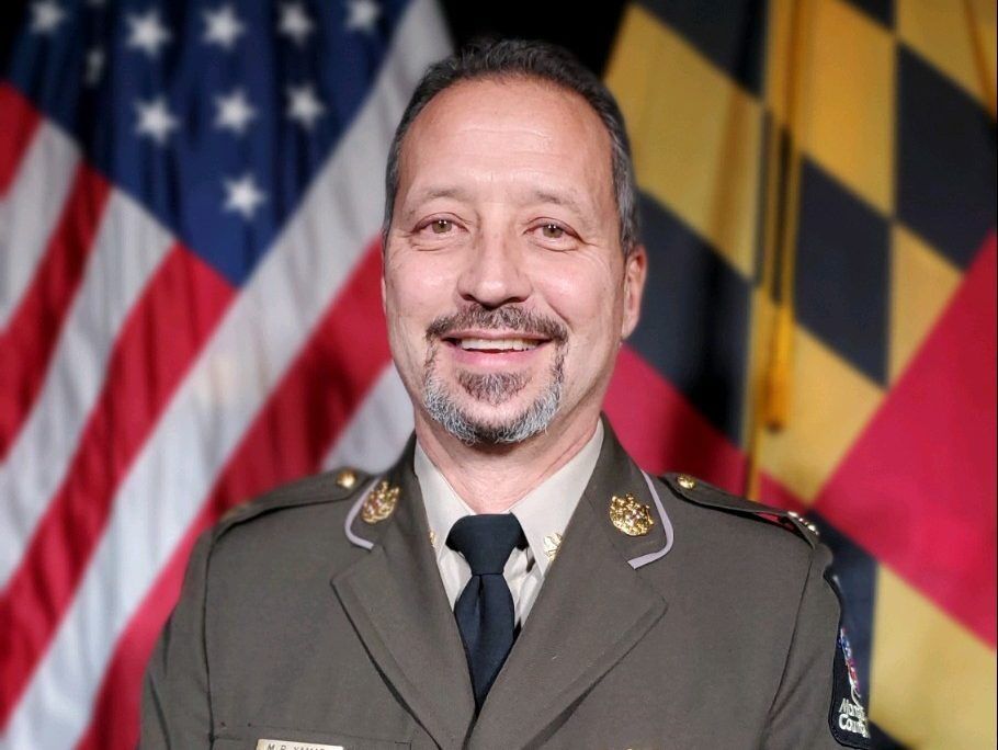Headshot of Chief Marc Yamada with American flag and Maryland flag as the backdrop.