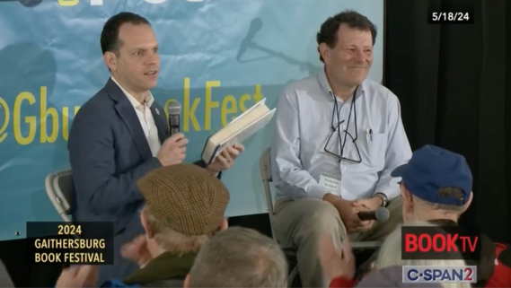 A photo of Councilmember Glass in conversation with Nicholas Kristof