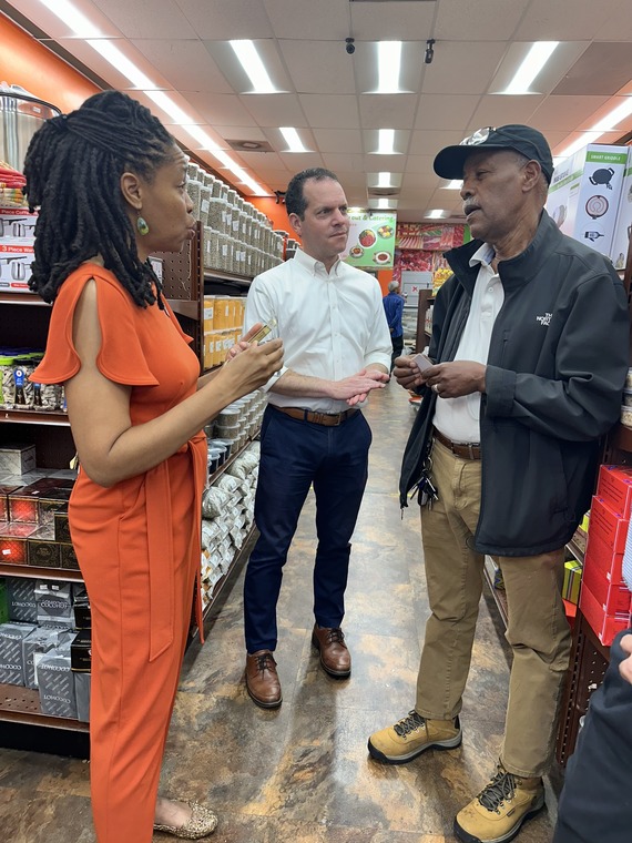 Councilmember Glass speaking with two people in a convenience store