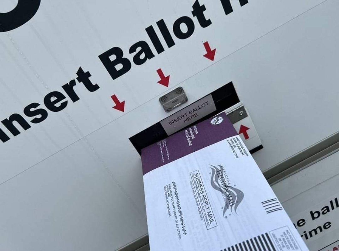 Mail-in ballot inserted into ballot box.