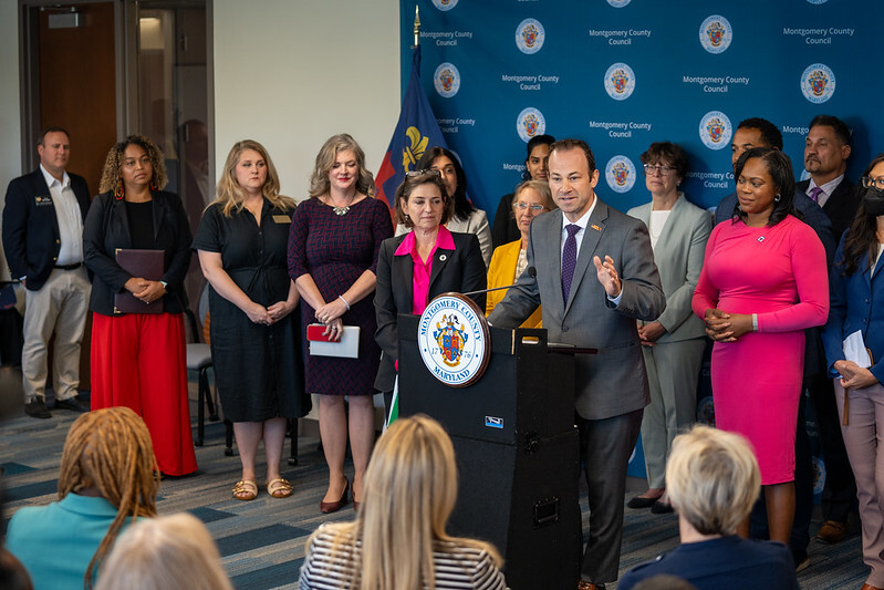 Council President Friedson speaking at a podium for the reproductive rights press conference.