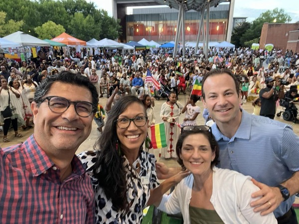 Councilmembers pose for a selfie with a large crowd at Ethiopian Day celebration.