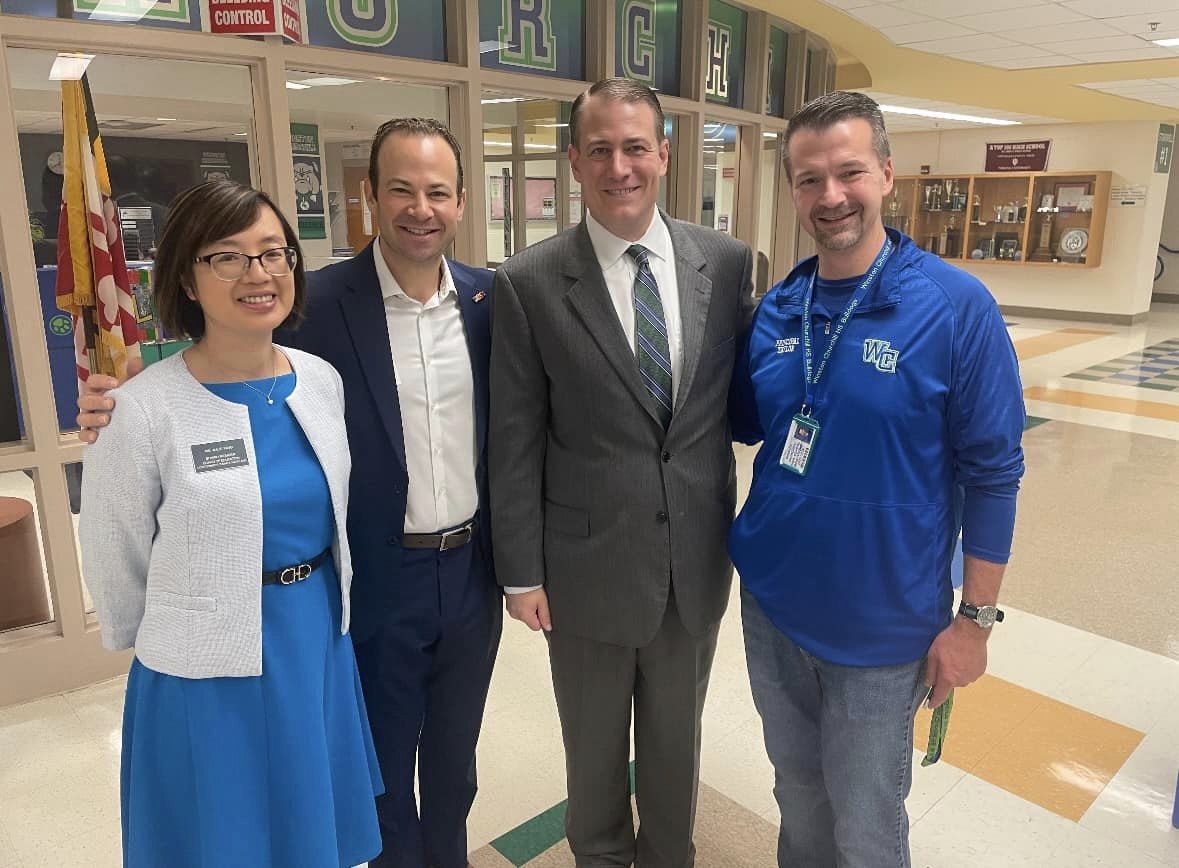 Left to right: Yang, Friedson, Superintendent Taylor and Churchill Principal Taylor smile inside of the school building.