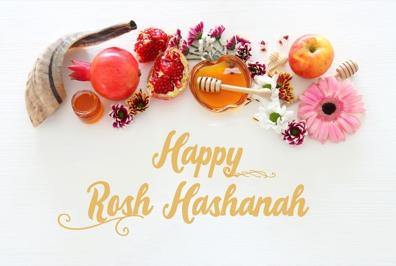 Spread of fruit, honey and flowers and “Happy Rosh Hashanah” message.