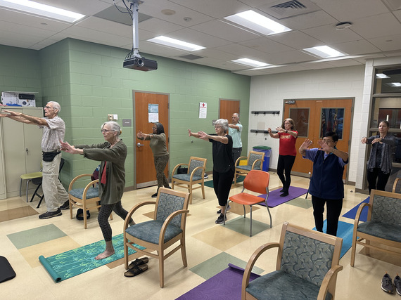 older men and women practicing yoga and tai chi