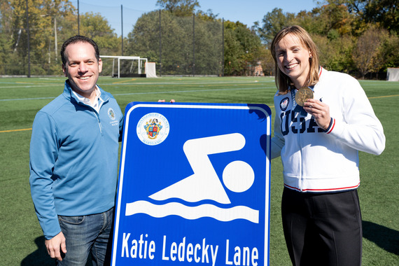 Councilmember Glass and Katie Ledecky with the new roadsign