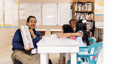 Preschool teacher reading to children