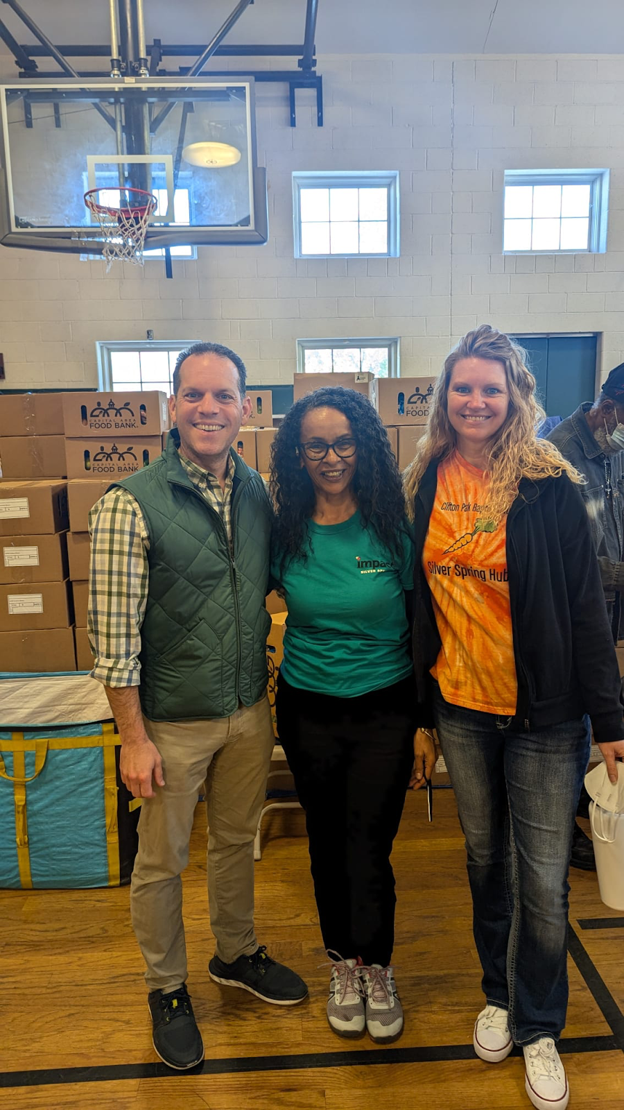 Councilmember Glass with two of the church community members who oversee the food bank