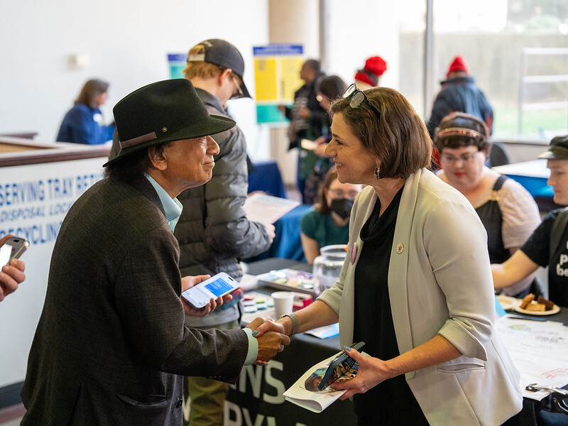 Council President Stewart shakes hands with a community member at the resource fair.