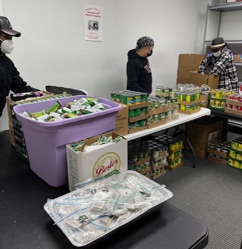 Volunteers packaging food.
