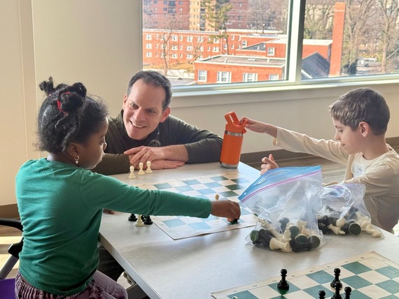 Councilmember Glass encourages kids playing chess