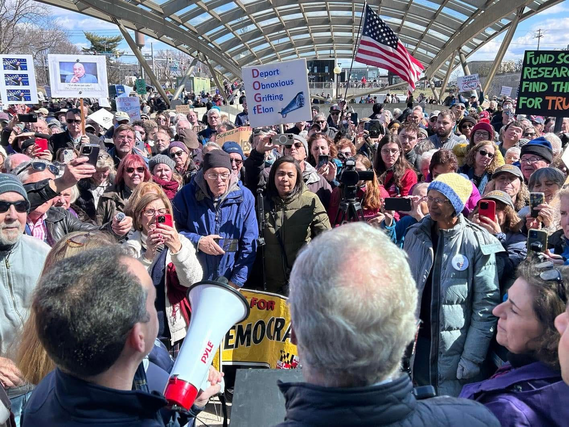 Councilmember Glass and Senator Van Hollen speak to the crowd rallied at NIH