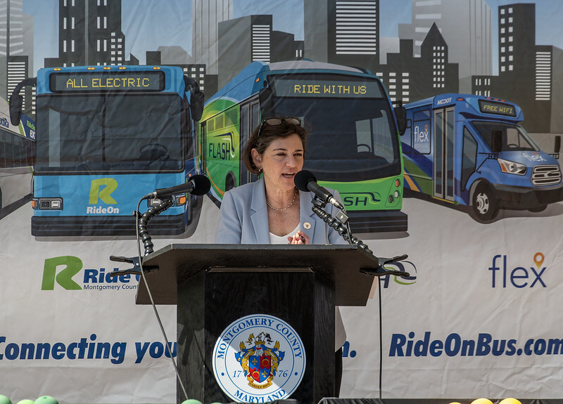 Council President Stewart speaks at a podium at the MCDOT Ride On bus system’s 50th Anniversary in Wheaton.