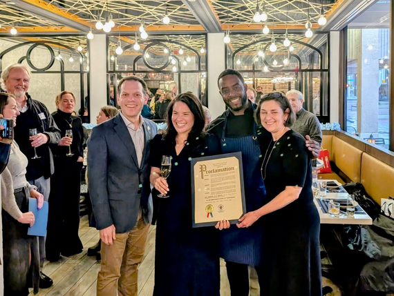 Councilmember Glass and Councilmember Kate Stewart stand with the owners of All Set Restaurant and Bar holding a proclamation
