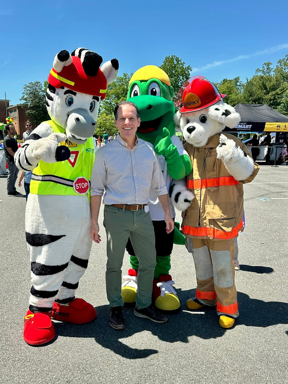 Councilmember Glass with three of MCDOT's safety mascots