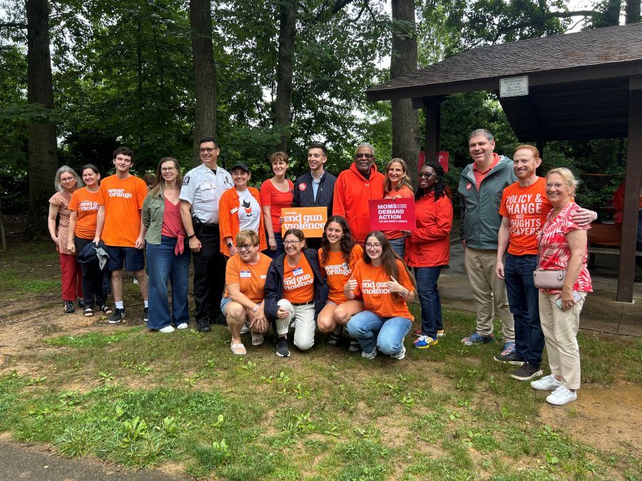 A group of County leaders and community advocates wear orange “End Gun Violence” t-shirts for Wear Orange weekend.