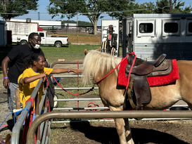 VIP participant and father petting a horse
