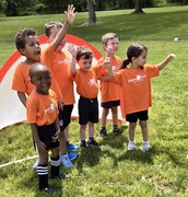 A children's soccer team celebrating with a group picture