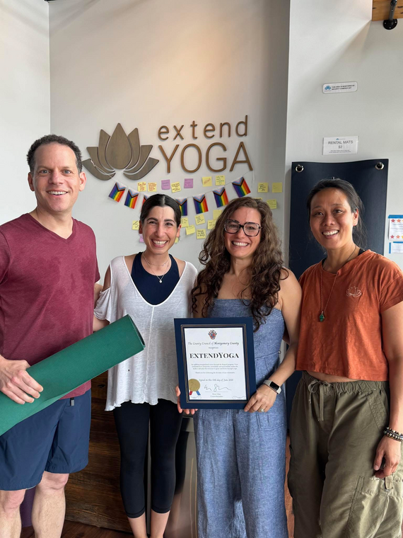 Councilmember Glass with three women who teach at and manage extendYoga