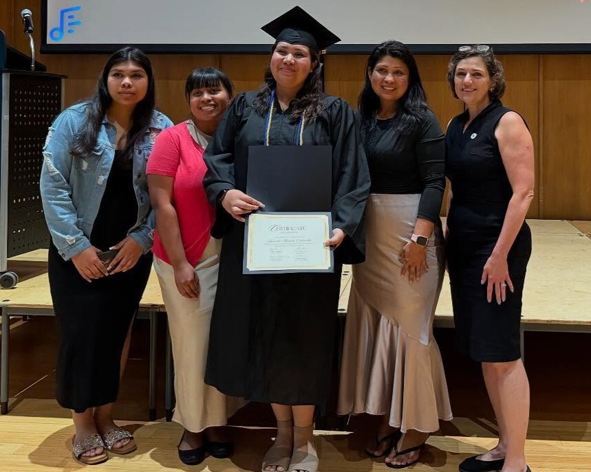 Council President Stewart with a LAYC graduate and family members.