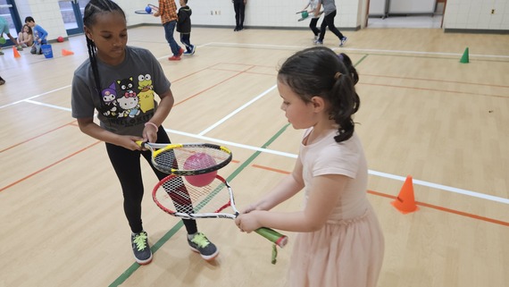 Two girls playing in the gym